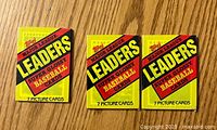 Front side of 3 sealed Topps Major League Leaders Super Glossy Baseball Card packs labeled '7 Picture Cards'