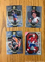 Four Wayne Gretzky hockey cards showing front views, including three Upper Deck 'The Gordie Collection' cards and one Captains series card with patch.