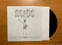 Front cover of AC/DC Flick of the Switch vinyl showing artwork and record partially inside white sleeve.