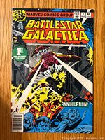Front cover of Battlestar Galactica #1 comic book showing space battle and characters with Marvel Comics Group branding and pricing details.