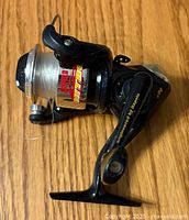 Side view of Rapala Nitro fishing reel showing handle, spool, decals, and fishing line.