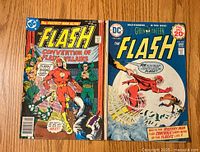Front cover of The Flash Issue #228 and #254 comics side by side on wood surface, showing cover art and titles.