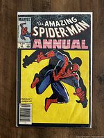 Front cover of The Amazing Spider-Man Annual #17 comic book showing Spider-Man in action pose with a yellow background and black silhouettes.
