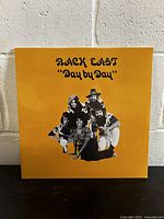 Front cover of the vinyl record showing album title and band photo on yellow background.