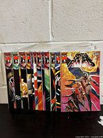 Front view of 12 Battle Of The Planets comic books arranged side by side showing colorful covers with issue numbers #1-#12 visible.