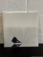 Front cover of the vinyl with abstract black ink art on white background