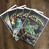 Photo showing all five Darkewood comic books, issues 1-5, laid out side by side on wood flooring, each individually bagged in protective plastic sleeves.
