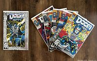 The six Doom 2099 comic books laid side by side, with Doom 2099 #1 shown separately to the left. This overview photo shows the full lot and condition.