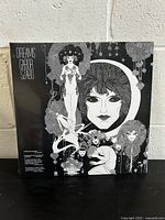 Front cover of the sealed vinyl record album 'Dreams' by Gabor Szabo with black and white illustrated artwork showing stylized female figures and a large face within a circular design.