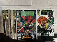 Stack of Green Lantern comic books from issue #2 to #30, displayed side by side leaning against a wall, each bagged individually.