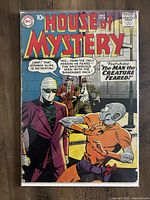Front cover of House of Mystery issue #88 with the bandaged face man and alien creature characters.