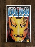 Front cover of Iron Man 2020 graphic novel showing detailed illustration of Iron Man's helmet with title and creators' names.