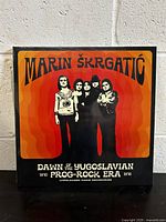 Front cover of the vinyl record with band photo and title.