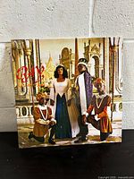 Front cover of the vinyl showing royal court-themed photograph with title in red.