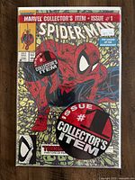 Photo of Spider-Man #1 comic book sealed in a collector bag, showing front cover with Spider-Man crouching and logos and text indicating collector's status and issue number.