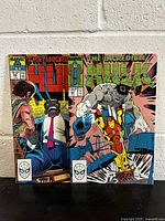 Photo showing covers of The Incredible Hulk comic books #356 and #361 with Marvel branding and action scenes.