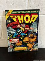 Front cover of The Mighty Thor Marvel Treasury Edition 10 comic book showing a colorful action scene with Thor fighting and the title prominently displayed.