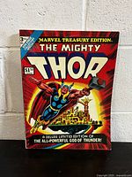 Photo of the front cover of The Mighty Thor Marvel Treasury Edition No. 3 comic book showing colorful artwork of Thor flying with his hammer.