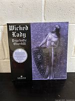 Front cover of the vinyl showing surreal art with a nude figure holding shield and sword wearing gas mask.