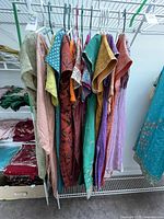 Photo capturing a portion of the traditional Indian clothing with various brightly colored kurtas displayed on hangers.