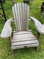 Front view of the Adirondack chair showing slatted design and wide armrests.