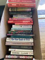 Box with a stack of 21 paperback books visible, showing titles and authors, edges in good condition.