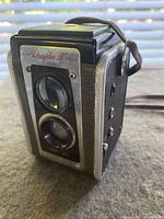 Front angle showing dual lenses and brand name plate