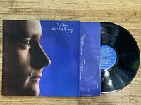 Vinyl record and cover featuring Phil Collins and album title