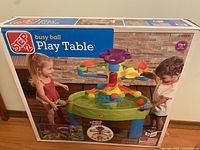 Box front showing Step 2 Busy Ball Play Table with children playing.