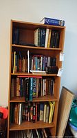 Full bookshelf with various books in hard and soft covers