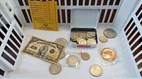 Overview photo showing Dominion of Canada 25 cents bill, various coins in a box, loose coins and some in protective sleeves.