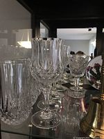 Photo of clear glassware including wine glasses and water glasses with crystal-cut pattern.