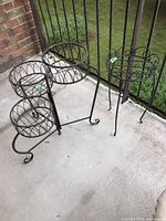 Both metal plant stands together showing size and condition with visible rust.