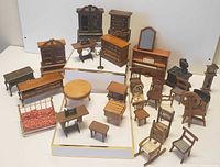 Full assortment of miniature vintage dollhouse furniture displayed on white background. Includes various wooden pieces and brass frame sofa.