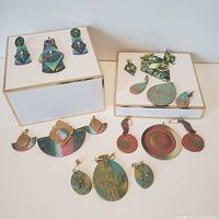 Polymer jewelry lot displayed with various earrings and pendants on white background, showing detailed shapes and colors.
