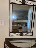 Wall mirror with matching metal frame detail