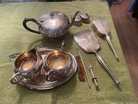 Overall view of teapot, sugar, creamer, tray, grooming pieces