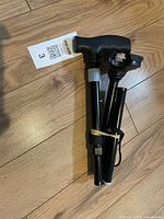 Cane folded showing ergonomic handle, shaft sections, wrist strap