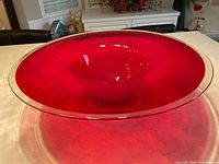 wide view of entire red glass bowl on countertop