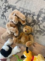 Group shot of brown rabbit and teddy bear with others partly visible
