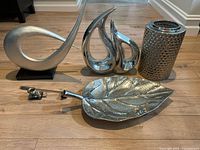 Group view showing all six silver-tone items on floor