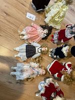 Group of dolls lying and standing showing clothing variety