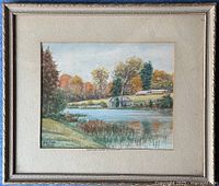 Framed watercolor landscape painting showing Indian River with fall foliage and a small building on the shore, signed by H. G. Lewis.