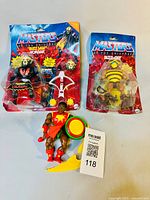 Two packaged figures and one loose figure arranged on white background, showing original packaging and accessories.