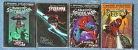 Photo of four Spider-Man graphic novels laid out side by side on a blue surface showing full front cover artwork and title details.