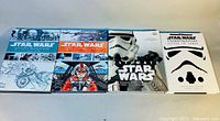 Four hardcover Star Wars books laid side by side, showing the front covers featuring storyboard art and iconic imagery.
