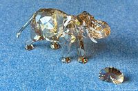 Elephant figurine and separate plaque on blue backdrop