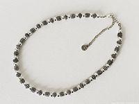 Full view of the vintage Napier necklace showing silver-tone textured and smooth beads with chain extender.