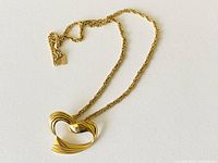 Photo shows vintage Vendome necklace with large heart-shaped gold plated pendant and twisted rope gold chain.