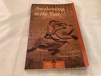 Front cover of 'Awakening to the Tao' softcover book, showing title, author, translator, and artwork.